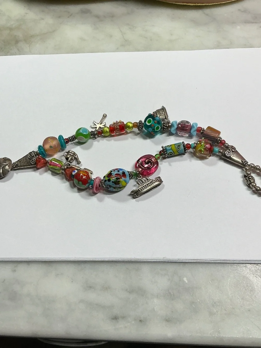 Sterling Silver and Lampwork glass beads W/ 4 Sterling Silver charms. 7.5” long